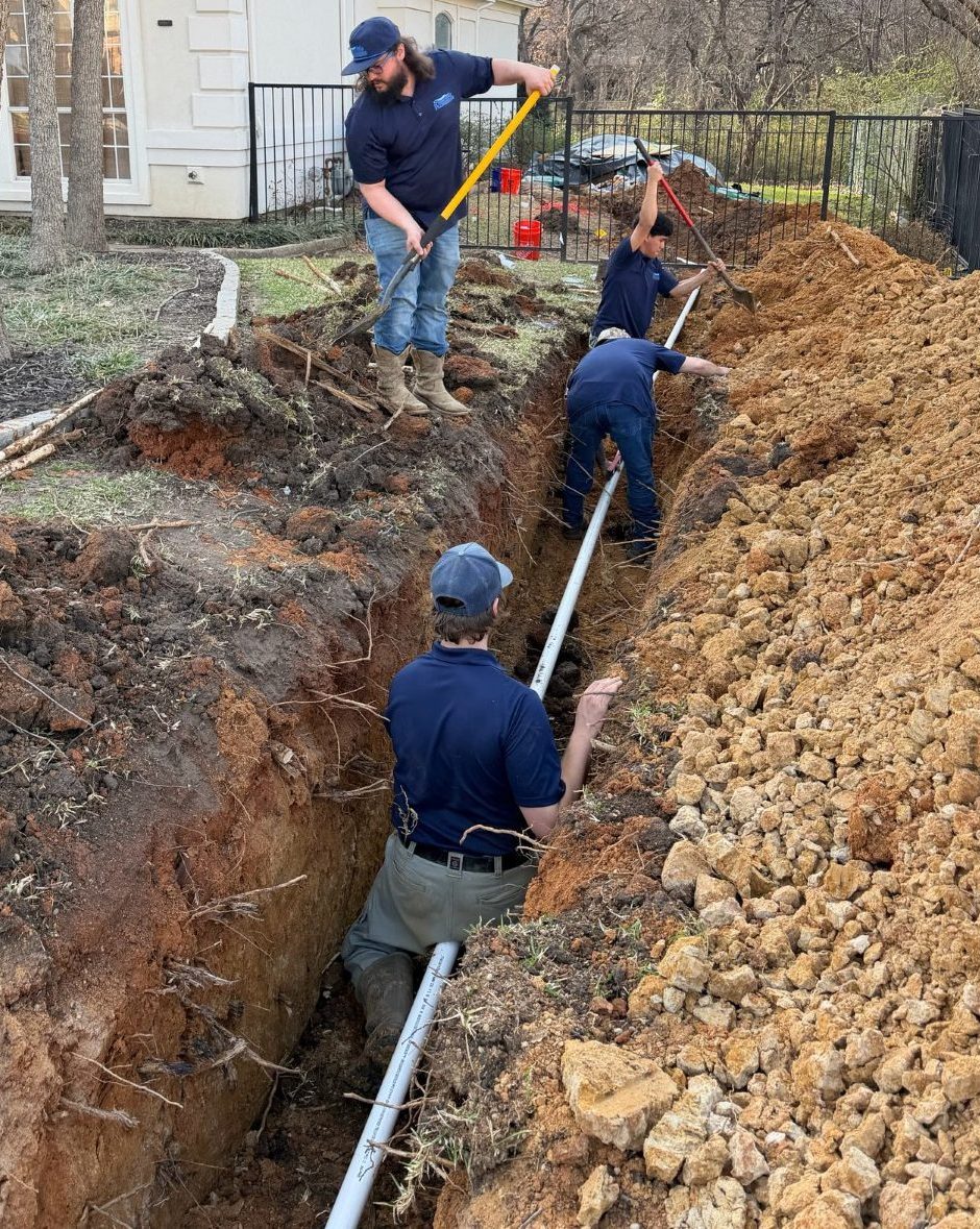 FlowMo Plumbing Teamwork Installing Pipes in Ground