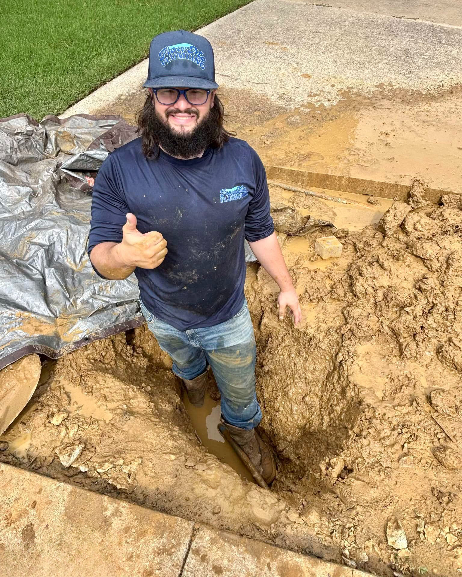 FlowMo Plumbing repairing main water line under the driveway after storm